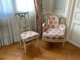 two chairs in the corner of a room next to a window
