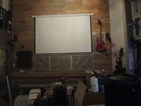 a picture of a room with a projector screen in the middle of the room