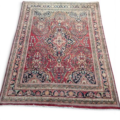 a red and blue rug with a medallion design on it