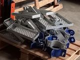 a pile of metal items on a pallet in a garage