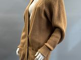 an image of a mannequin wearing a brown sweater and white pants