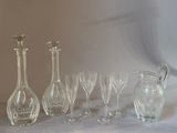 a group of wine glasses and a decanter on a table