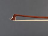 a close up of a violin ' s bow on a gray background