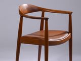 an image of a wooden chair with a brown leather seat