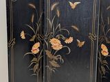 a black room divider with flowers and butterflies on it