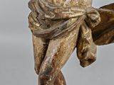 statue of a man on a wooden base holding a sword