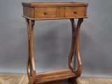 an old wooden table with a drawer on top of it on a wooden floor