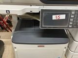 an image of a printer sitting on top of a pile of other printers