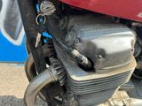 un gros plan d'une moto rouge garée dans la rue