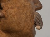bronze statue of a man with a mustache and a moustache