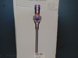 the box of a dysonon cordless vacuum is open on a table