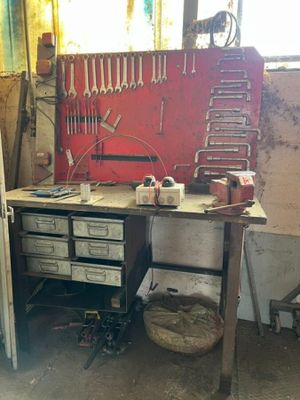 a workbench with tools on it in a garage