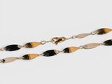 a pair of black and gold chain bracelets