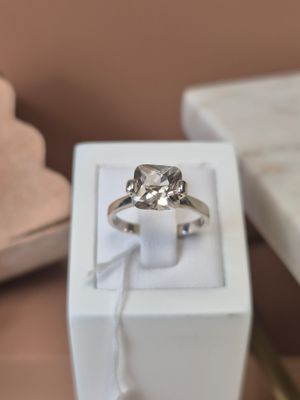 a diamond ring in a white box on a table