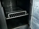 a small oven with a door open and a rack in it