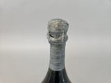 a bottle of wine that has a crack in the top of it