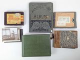 many old books on a white table with pictures