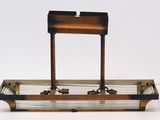 a metal and glass tray with a wooden stand