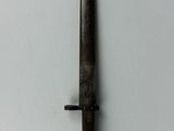 a close up of a knife on a white surface