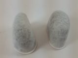 pair of salt and pepper shakers sitting on a white surface