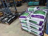 many bags of cement on a pallet in a warehouse