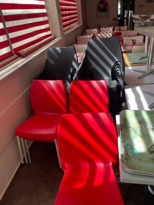 many red and black chairs and a table in a room
