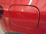 a close up of a red car door handle