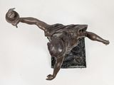 a bronze statue of a woman with a hat on her head