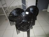 four plastic chairs sitting on a tiled floor in a room