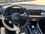 the interior of a car with a steering wheel and dashboard controls