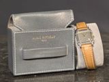 a watch and a watch case on a table