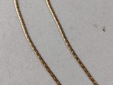 a gold necklace with a chain that is attached to it