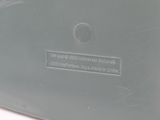 a close up view of a gray vase with a label on it
