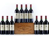 six bottles of red wine in a wooden crate on a white background
