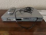 an image of a dvd player sitting on top of a wooden table