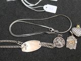a silver necklace with charms on it on a black surface