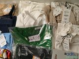 a lot of clothes that are sitting on a table