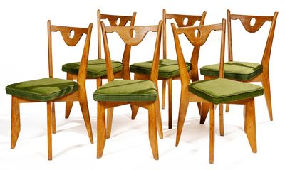 six wooden chairs with green cushions on them