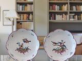 two plates that are sitting on a table in front of a bookshelf