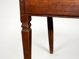 a small wooden table with a drawer on it