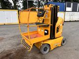 a yellow forklift sitting in the middle of a parking lot