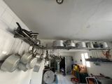 pots and pans hanging on the wall in the kitchen