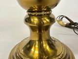 a gold colored lamp that is sitting on a table