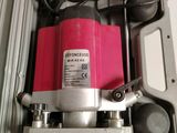 a red and silver machine in a plastic container