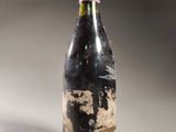 a bottle of wine that has been left on the table