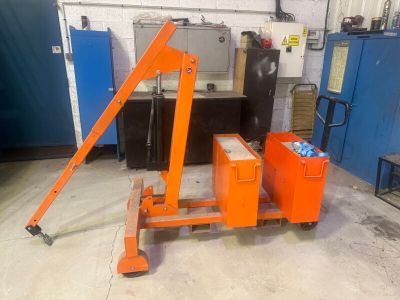 a large orange crane that is sitting in a garage