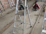 many ladders that are sitting in a room
