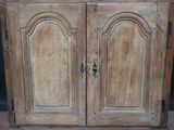 an old wooden cabinet with two doors and a door handle