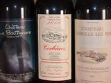 several bottles of wine are lined up on a table