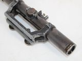 a gun that is sitting on a white surface